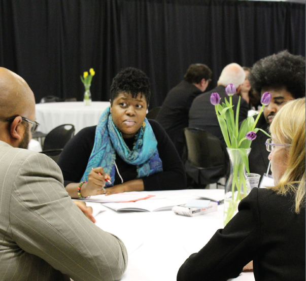 Planning committee at a table with open workbooks